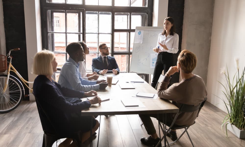A sales coach giving a flip chart presentation to sales team.