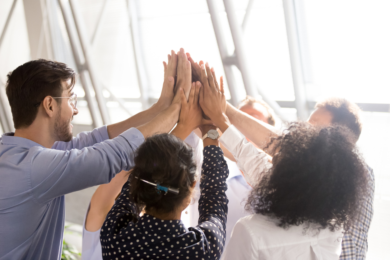 A group of people high-fiving. 