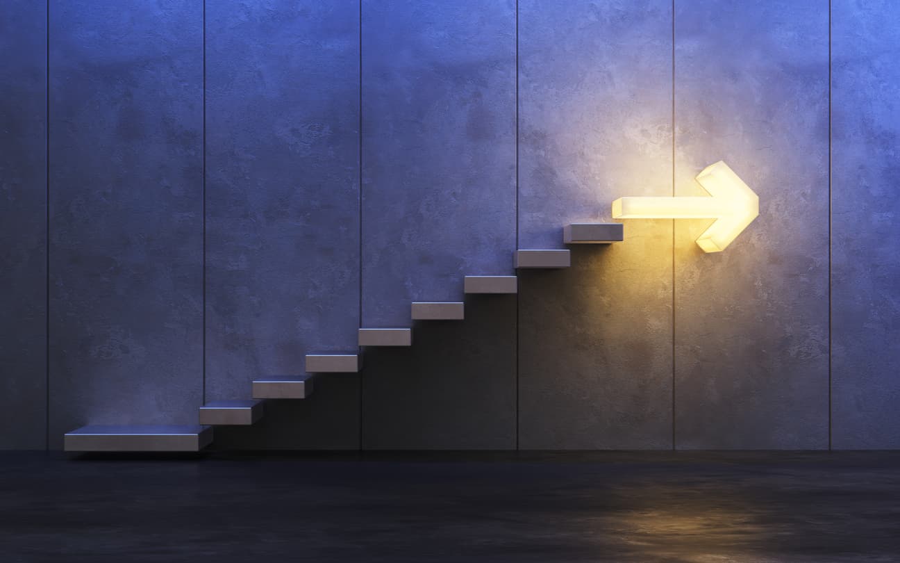 Staircase with a glowing arrow at the top 