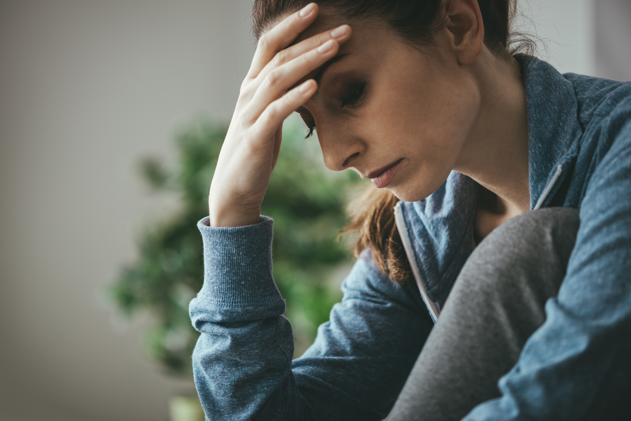 Depressed woman leaning on her hand
