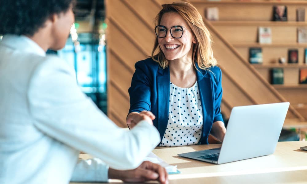A salesperson smiling after closing a deal.