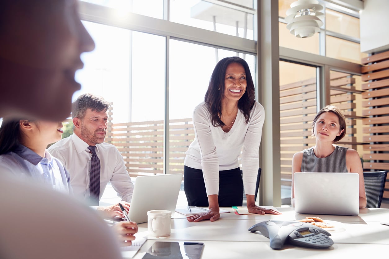 a smiling black female leadership team run a team meeting 
