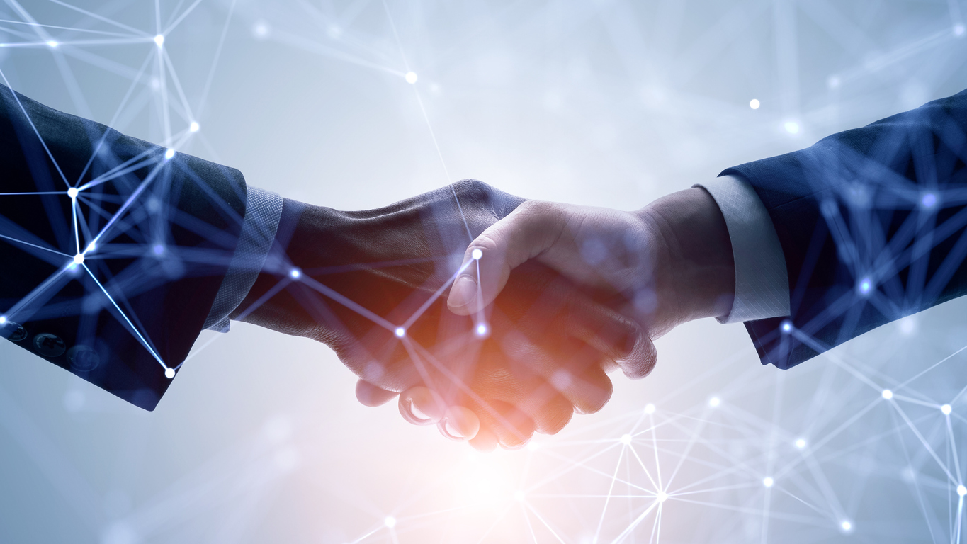 Hands shaking over a background of automated touchpoints.
