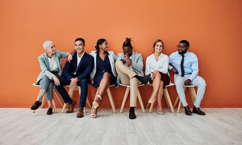 A group of candidates wait to meet with a sales recruitment person.