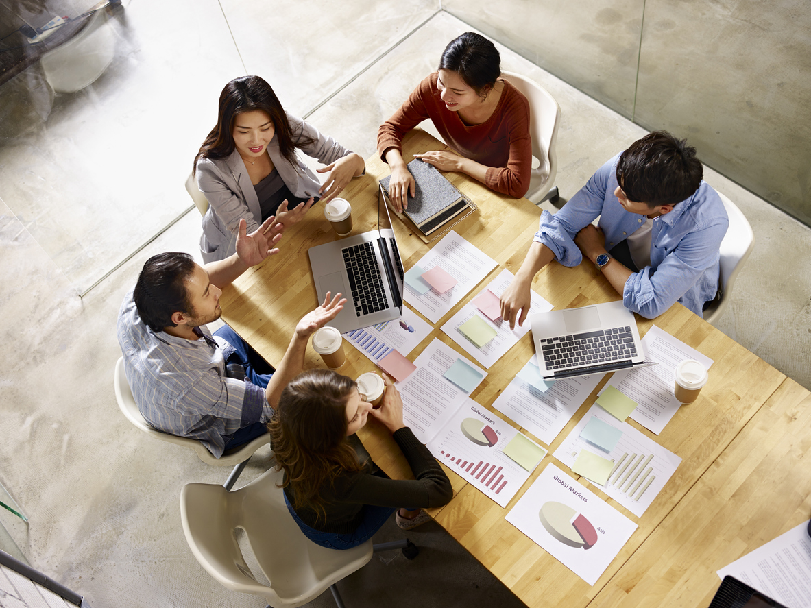 Group of people sitting at a table in an office
